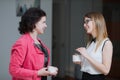 Work colleagues in the office talking to each other during the break