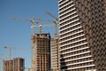 Work on the construction site. Unfinished tall houses