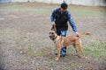 Almaty, Kazakhstan - 11.04.2014 : A dog handler prepares for training with a service dog