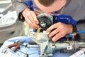 Automotive worker repair a steering wheel column