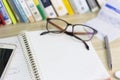 Work desk with book, pen, glasses, and workspace Royalty Free Stock Photo