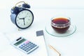 A work desk with a computer and office accessories and an alarm clock measuring the time running away. The concept of urgent deadl Royalty Free Stock Photo