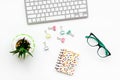 Work desk of creative person. Computer keyboard, glasses, bright stationery, plant on white background top view Royalty Free Stock Photo