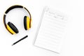 Work desk of modern composer. Music notes near headphones on white background top view Royalty Free Stock Photo