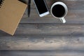 Work desk wood table with notebook,smartphone,pen and coffee cup Royalty Free Stock Photo