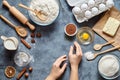 Work with the dough. The kitchen table raw ingredients, the woman`s hand ready to knead the preparing ginger cake