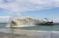 Work dredger dredging with sand washing on beaches. Special dredging hose for sand to create new land. Sand washing on sea Royalty Free Stock Photo