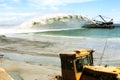 Work dredger dredging with sand washing on beaches. Special dredging hose for sand to create new land. Sand washing on sea Royalty Free Stock Photo