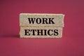 Work ethics symbol. Concept words Work ethics on brick blocks. Beautiful burgundy background. Business and Work ethics concept. Royalty Free Stock Photo