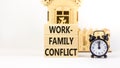 Work-family conflict symbol. Concept words Work-family conflict on wooden block on a beautiful white table white background. Black Royalty Free Stock Photo