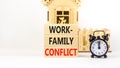 Work-family conflict symbol. Concept words Work-family conflict on wooden block on a beautiful white table white background. Black Royalty Free Stock Photo