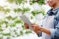 Work on farm concept. Farmer checking quality greenhouse with tablet Royalty Free Stock Photo