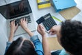 Female hands typing on laptop, male hands holding credit card Royalty Free Stock Photo