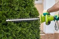 Work in the garden. The gardener is cutting plants. Hedge trimmer works. Hedge trimmer in action. Home and garden concept. Work Royalty Free Stock Photo