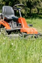 Work in the garden. lawn mower cutting green grass in backyard. Royalty Free Stock Photo