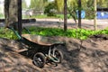 Work in garden - wheelbarrow at the edge of the garden heap - image