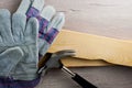 Work gloves on building materials and tools. Workplace safety concept. Occupational Safety and Health, DIY.