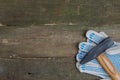 Work gloves with a hammer on an old wooden table Royalty Free Stock Photo