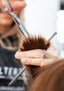 The work of a hairdresser. Hairdresser cut hair of a woman  in a beauty salon. Close-up of hands Royalty Free Stock Photo