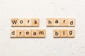 Work hard dream big word written on wood block. Work hard dream big text on cement table for your desing, Top view Royalty Free Stock Photo