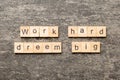 Work hard dream big word written on wood block. Work hard dream big text on cement table for your desing, Top view Royalty Free Stock Photo