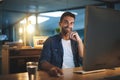 Work hard now so we can play more later. Portrait of a handsome young businessman smiling while working late at night in