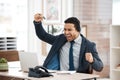 Work hard now and youll reap what you sow later. a young male call center agent cheering while using a laptop in an Royalty Free Stock Photo