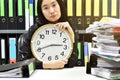 Work hard, Office worker holding a clock, Working overtime and lot of work Royalty Free Stock Photo