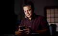 Work hard in silence - let success make the noise. a young businessman using a cellphone in an office at night. Royalty Free Stock Photo