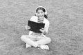 Work hard. small girl reading book. literature for kids. write childhood memories. smart kid in headset. back to school