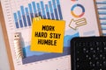 WORK HARD STAY HUMBLE text concept write on a notebook Royalty Free Stock Photo