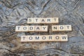 start today not tomorrow text on wooden square, motivation quotes. Royalty Free Stock Photo