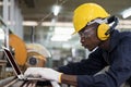 Work in a Heavy Industry Manufacturing Factory. Engineer or technician worker man using the laptop computer Royalty Free Stock Photo