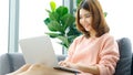 Work from home, Asian woman working with laptop computer at home, Asia female shopping online, Happy girl learning by internet, Royalty Free Stock Photo