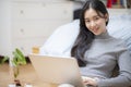 Work from home, Asian woman working with laptop computer at home office, Asia female shopping online, Happy girl learning by Royalty Free Stock Photo