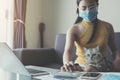 Work from home. Business Asian Woman freelancers with assintant cat working on laptops and computers at home. People at home in