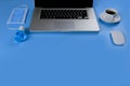Work from home concept. Laptop, black coffee. mouse, medical face mask, Blue alcohol hand sanitizer gel on blue background with