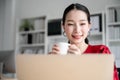 Portrait of beautiful young asian woman working on laptop in workplace Royalty Free Stock Photo