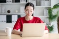 Portrait of beautiful young asian woman working on laptop in workplace Royalty Free Stock Photo