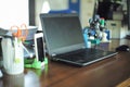 Work from home concept. Selective focus on laptop on the wooden table surrounded by the office stationaries with blurred Royalty Free Stock Photo