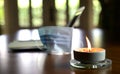 Work at home during coronavirus outbreak. Focus on burning candle on table with face mask and laptop at the background Royalty Free Stock Photo