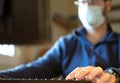 Work from home COVID-19 concept. Asia man wear medical mask using notebook computer working for social distancing meeting online Royalty Free Stock Photo