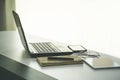 work from home, a glasses above laptop computer on a white modern business office desk table Royalty Free Stock Photo