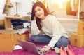 Work from home. happy female selling products online, start up small business owner using laptop computer on wooden floor Royalty Free Stock Photo