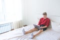 Work at home on the Internet. Freelancer works on a laptop in his bed room