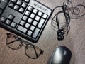 Work from home. office desk with keyboard, mouse, headshet, glasses and pen Royalty Free Stock Photo