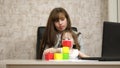 Work at home. in the room, mom works at the table with her little daughter at the computer. business woman working in Royalty Free Stock Photo