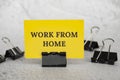 Work from home text on standing yellow paper. Working culture concept Royalty Free Stock Photo