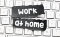 WORK AT HOME word on small black pages placed on a computer keyboard