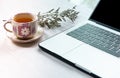 Work from home, workspace office at home, Notebook or laptop computer with Chinese tea cup  on the white desk at home office Royalty Free Stock Photo